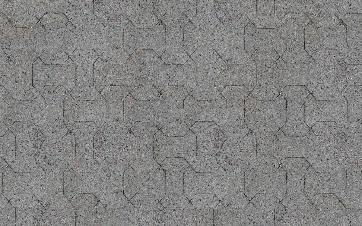 Grey concrete paving blocks laid in an interlocking pattern
